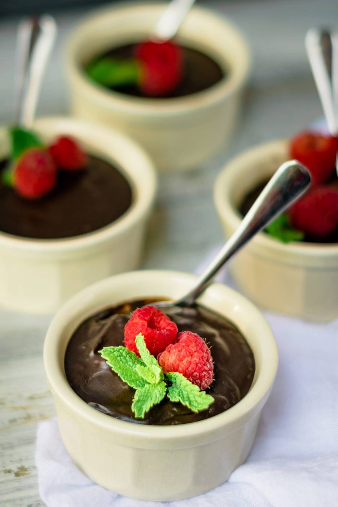 garnish homemade chocolate pudding with mint and raspberries
