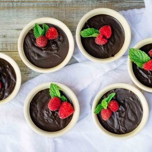 a group of homemade chocolate pudding cups makes for an elegant dessert display