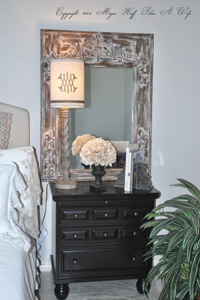 Bun feet black nightstand with lamp and tin surround mirror