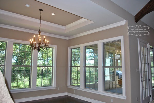 Dining room adjacent to sunroom with coffered ceiling
