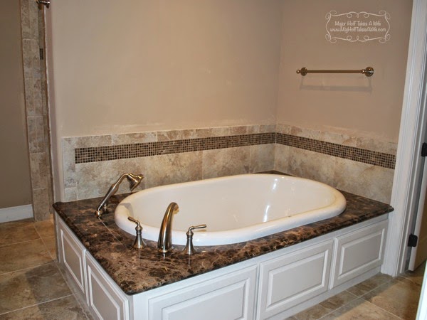 Master bath tub with shower sprayer and mosaic tile