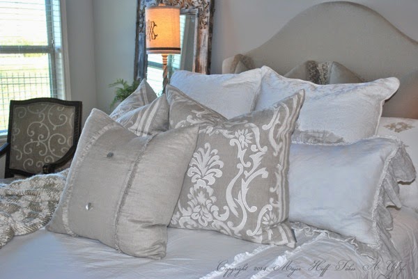 Upholstered headboard with curve and feminine pillows
