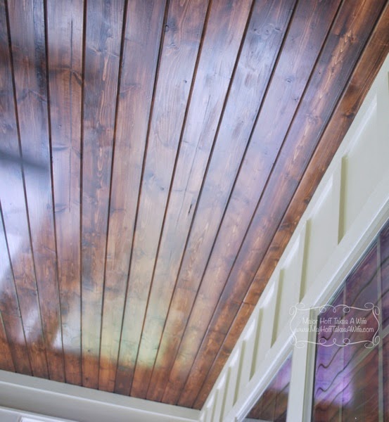 Planked stained wood ceiling on sun porch