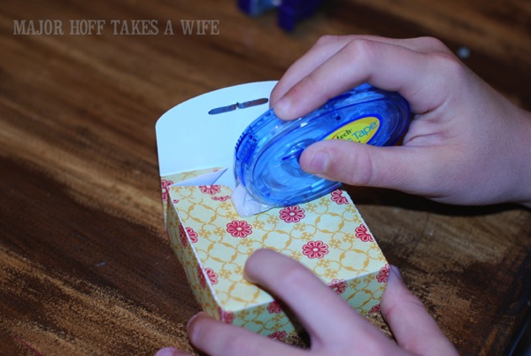 Apply tape to hold scrapbook paper box together