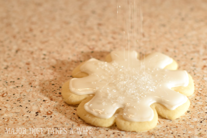 Sugar Cookies being decorated with sanding sugar.