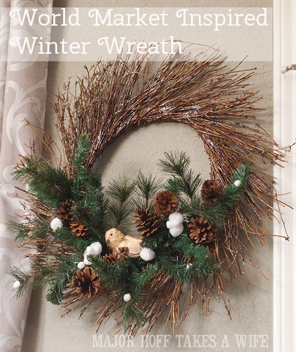 World Market inspired wreath. World Market inspired wreath. A fun twist on a Christmas wreath. Make a winter wreath that will last all season long and well past. This cute grapevine wreath is adorned with a tiny bird, pinecones, greenery and pom poms. You won't believe how cheap and easy this was to make! And so simple! #Christmas #winter #holiday #wreath #nature #knockoff