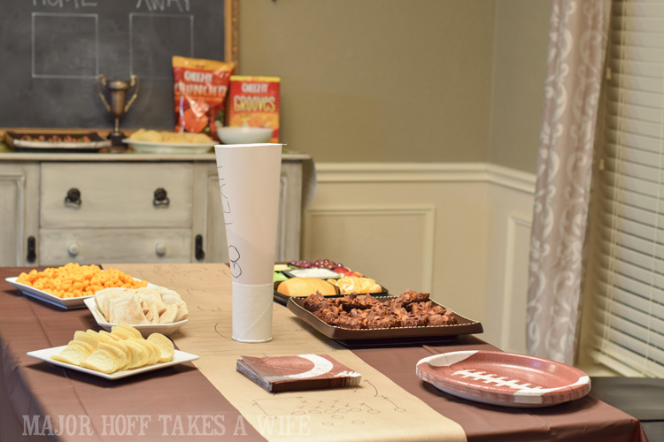 Football themed party table set up. An easy to throw party for the Big Game. Features easy party ideas for snacks, dips and decor. Includes a recipe for Roasted Red Pepper Hummus without seeds! #BigGameSnacks #collectiveBias #ad 