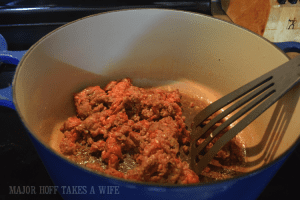 Saute Italian sausage in Le Creuset Pan for homemade marinara