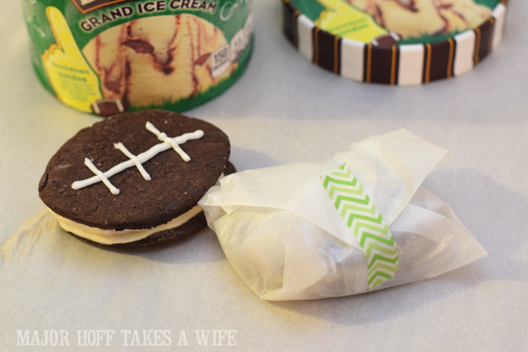 Wrap an ice cream sandwich for storage. Looking for a fun party for your teenage boy? Why not throw a Football video game party? Easy ideas for how to entertain kiddos during the Big Game. Features DiGiorno pizza, personalized football cups, free printable lanyards, and an incredible recipe for football shaped ice cream sandwiches! #GameTimeMVP #CollectiveBias #ad