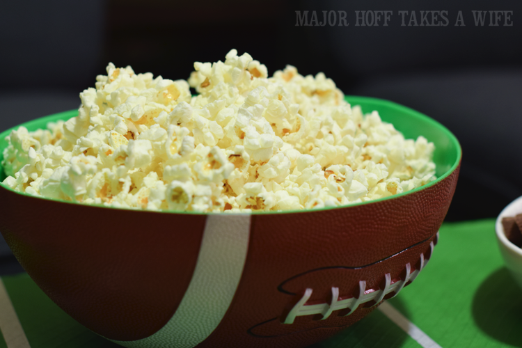 serve popcorn in a football bowl for a fun snack. Looking for a fun party for your teenage boy? Why not throw a Football video game party? Easy ideas for how to entertain kiddos during the Big Game. Features DiGiorno pizza, personalized football cups, free printable lanyards, and an incredible recipe for football shaped ice cream sandwiches! #GameTimeMVP #CollectiveBias #ad