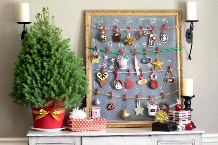 A dining room buffet features a handmade advent calendar using a mini Christmas tree and 24 ornaments