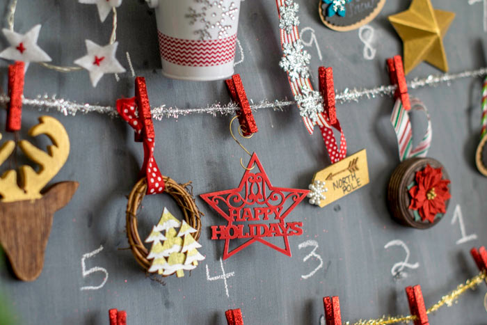 Small ornaments on a chalkboard for a DIY advent calendar craft