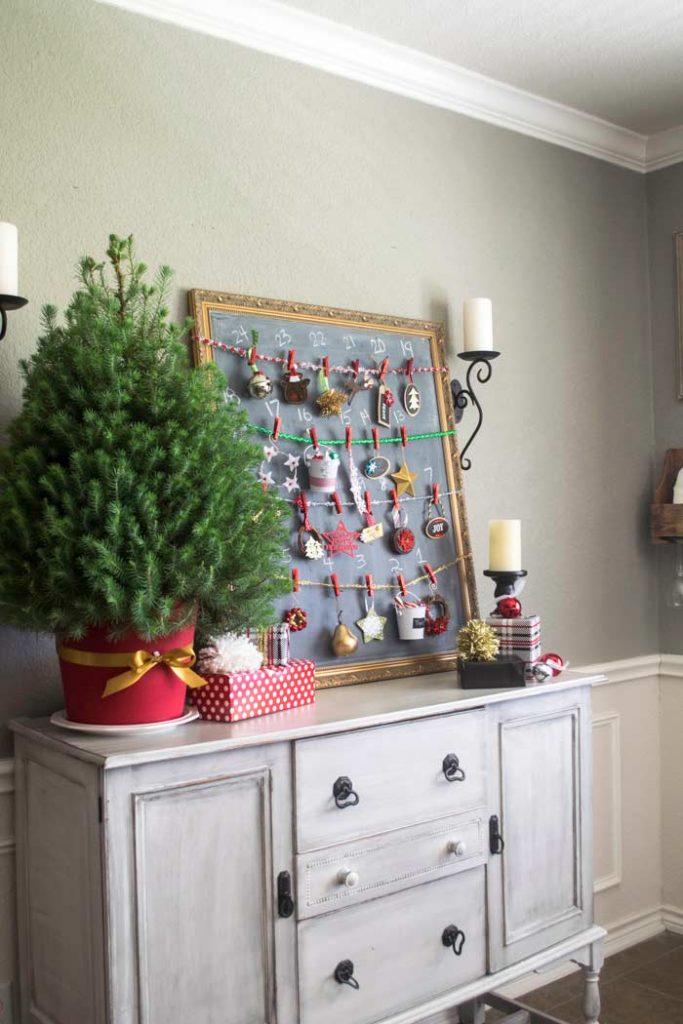 Dining room decorated for Christmas with a table top Christmas tree advent calendar on a buffet side table