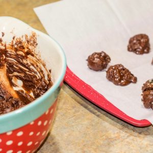 flourless peppermint chocolate cookie batter being scooped onto baking pan