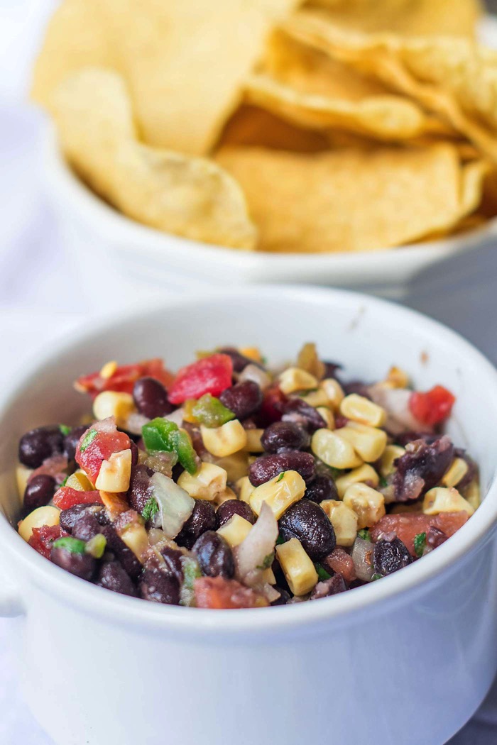 Served as an appetizer with chips or as a fresh summer salad, everyone loves 3 Pepper Black Bean and Corn Salsa! Full of black beans, corn and peppers!