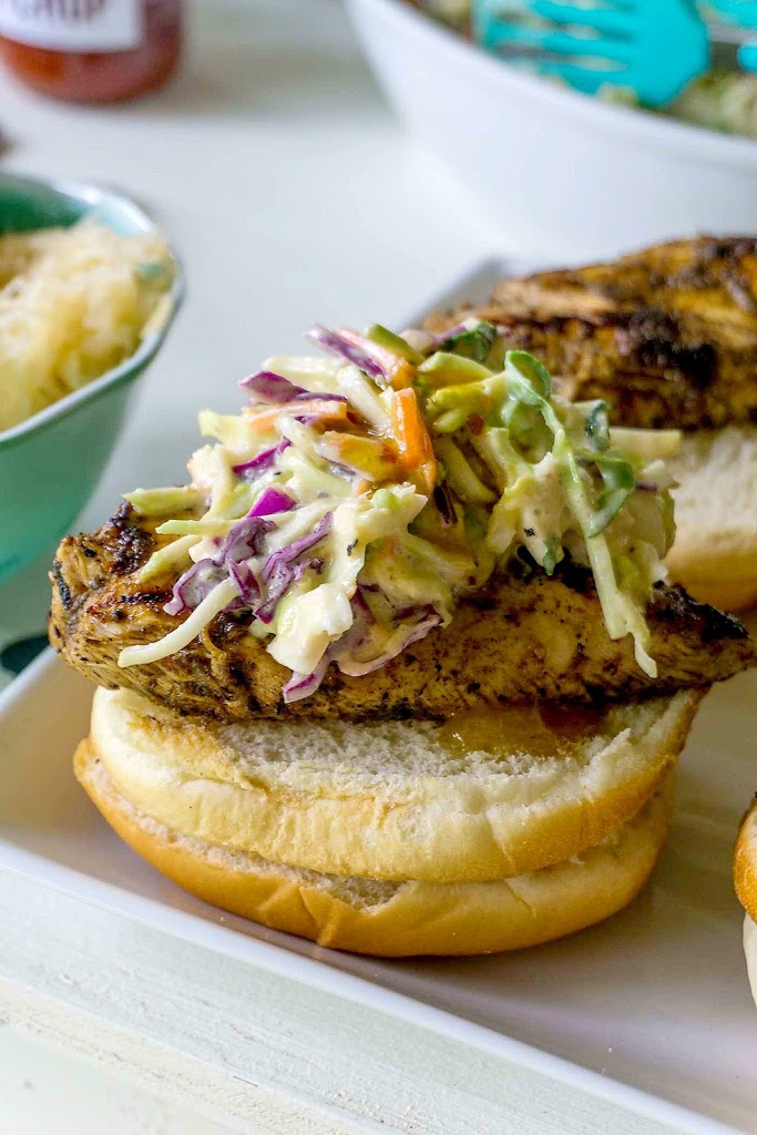 BBQ Heaven!  Jerk Chicken Sandwiches with Mango Chipotle Coleslaw! Spicy grilled chicken breasts are topped with a crisp sweet and spicy coleslaw! via @mrsmajorhoff