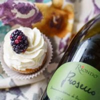 Prosecco Cupcakes with Blackberry Compote will wow your taste buds! Prosecco makes this delectable cupcake sophisticated enough for any dinner party.