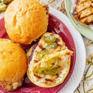 A spicy jalapeño cranberry jelly tops these grilled pork tenderloin sandwiches to make a fast and tasty weeknight meal in under 30 minutes!