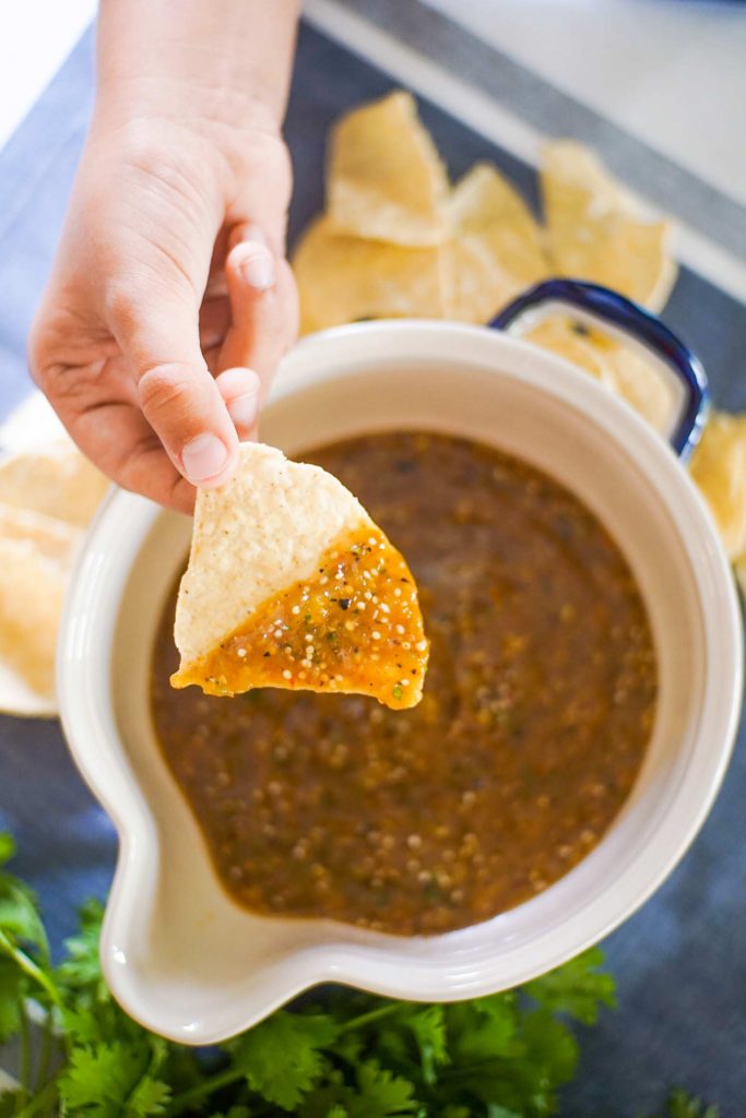 Learn how to make easy homemade tomatillo salsa at home. Tips and tricks to pick the right ingredients and make restaurant quality salsa at home!