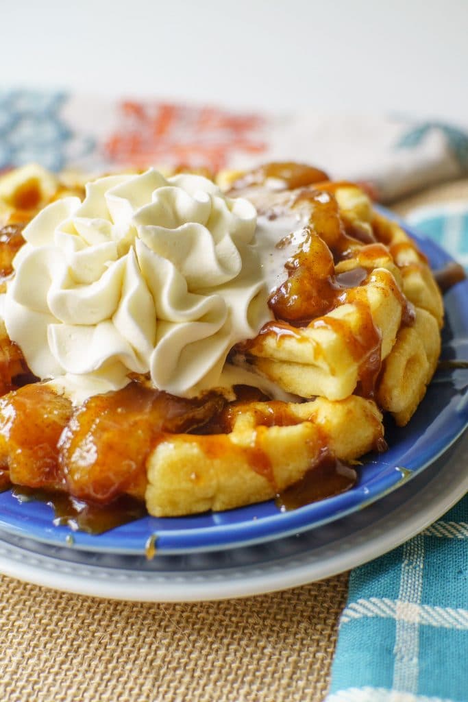 waffles with caramelized bananas and a whipped cream flower on top