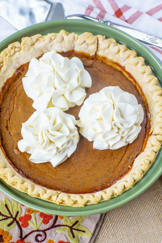molasses pumpkin pie with homemade stable whipped cream flower shapes