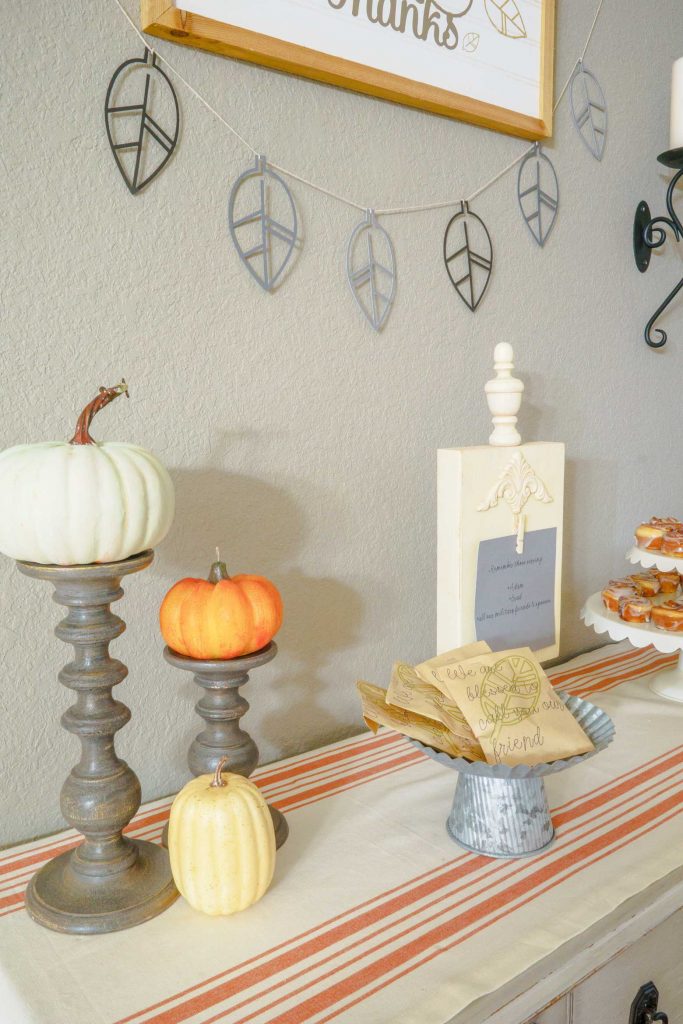 Looking for a modern rustic Thanksgiving tablescape? Use your Cricut to make these DIY chargers, a raw wood centerpiece, and wall art for the holiday!