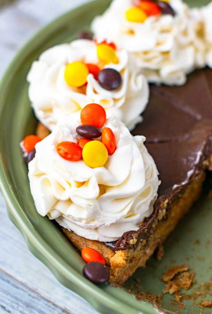 Reeses pieces chocolate pie with whipped cream flowers topped with reese's pieces candy