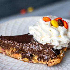 A slice of delicious Reese's pie with chocolate ganache and peanut butter cookie crust!