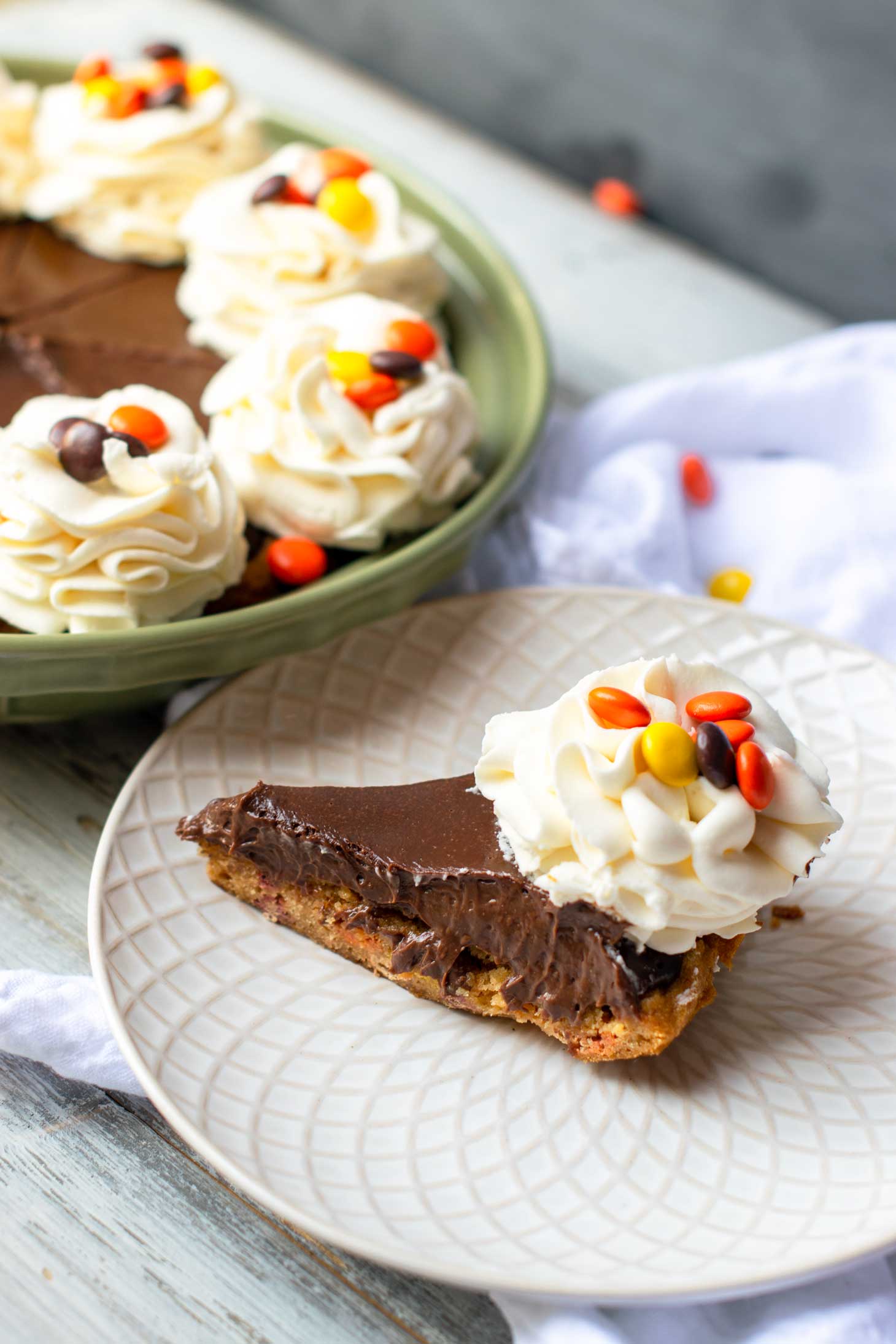 Reese's pie is a simple peanut butter pie with stabilized whipped cream flowers and Reese's Pieces