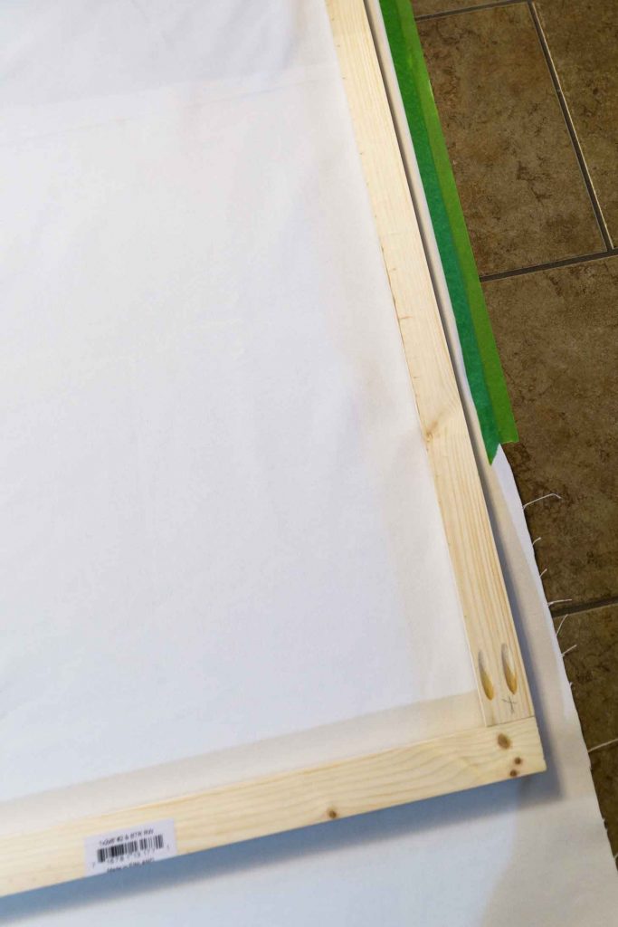 Use Frog tape to stabilize your canvas fabric before stapling it to your wooden frame