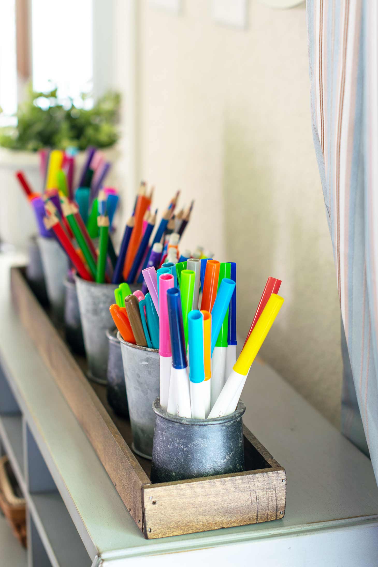 a desktop organizer tray holds markers pencils crayons and more