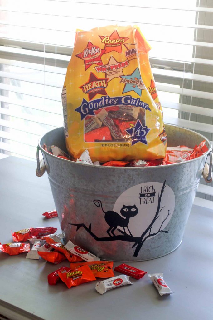 Place all your favorite mini candy bars in this decorated galvanized bucket for halloween