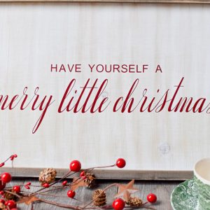 wooden whitewashed farmhouse sign with "have yourself a merry little christmas" in vinyl from an SVG file
