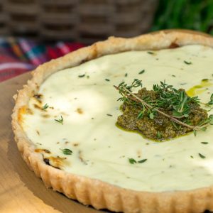 caramelised onion tart topped with goats cheese and pesto. Served at a picnic