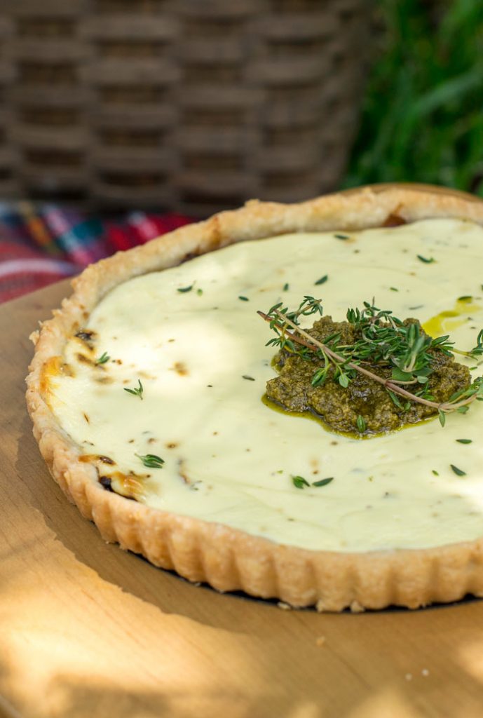 caramelised onion tart topped with goats cheese and pesto. Served at a picnic