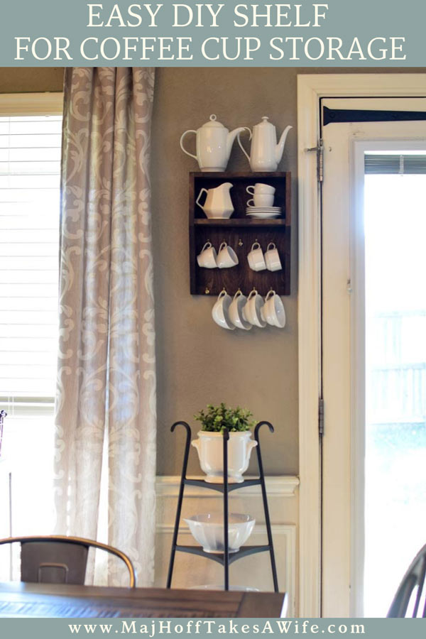 This easy DIY mug holder is so easy to make! Stain or paint an unfinished premade wooden wall shelf any color you'd like and add hooks for easy cup storage! Free up cabinet and countertop space. Match any decor and give your coffee cups a home! via @mrsmajorhoff
