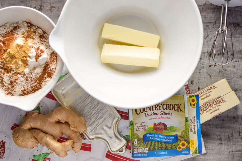 the start of gingerbread cookie dough requires fresh ginger, flour and spices and butter in a bowl