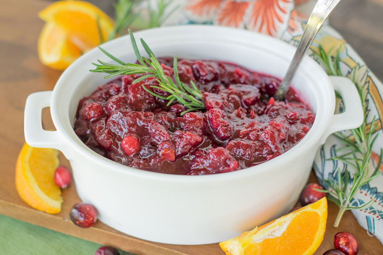 You only need a few ingredients to make the best ever cranberry sauce. Served in a white side dish it will pop on your Thanksgiving table!