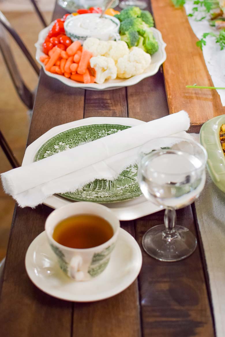 green and white ironstone dishes on a Thanksgiving table