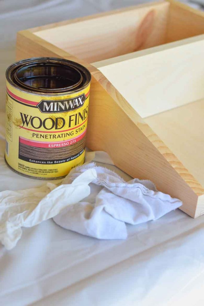 Using minwax to stain a pine shelf with old t-shirts and a plastic disposable glove