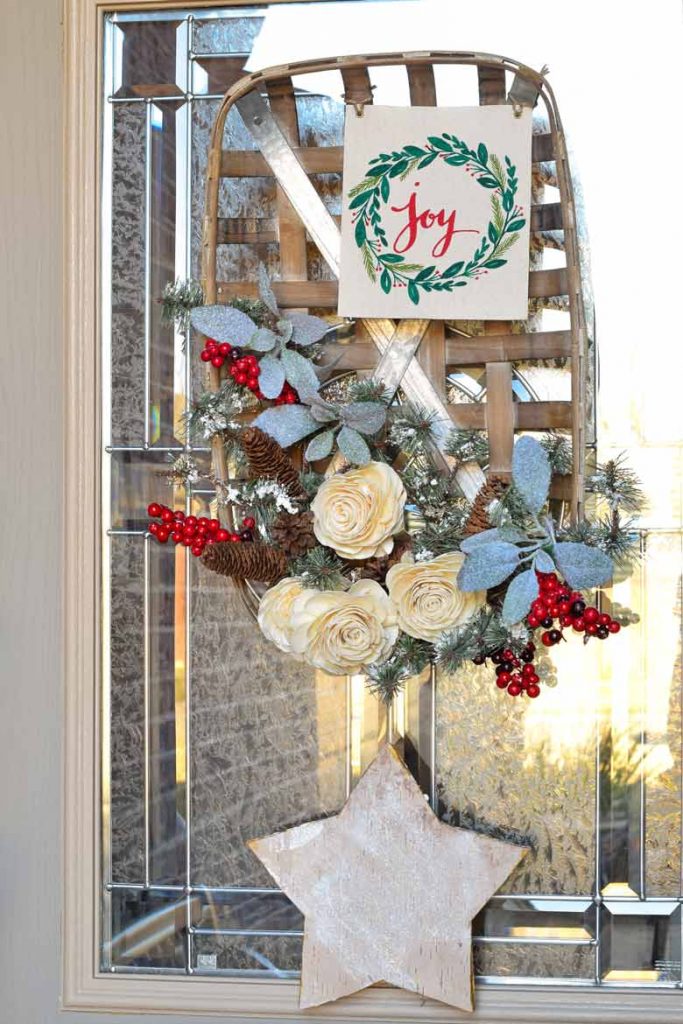 Christmas Front Door Wreath made from a basket, roses, evergreen and berry picks and more!