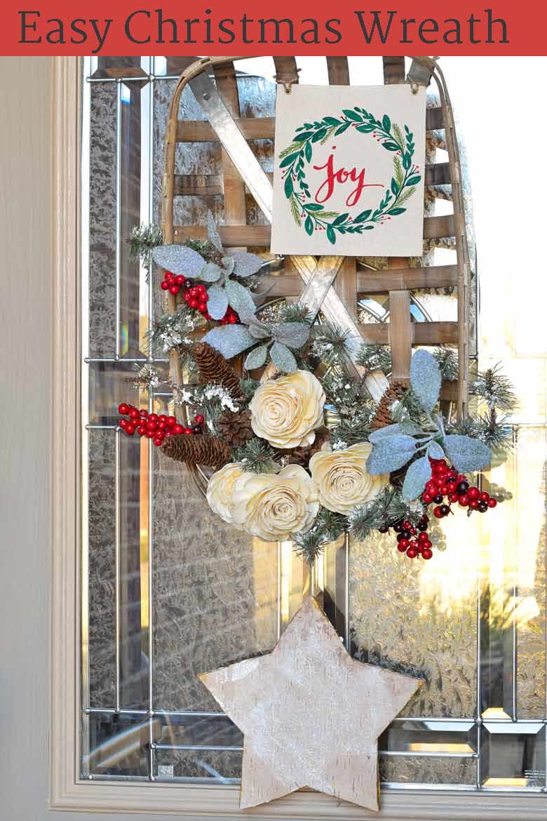 A winter wreath on your front door is a cozy welcome to all your guests. This tutorial will show you how to make a basket wreath for Christmas and beyond! See the step by step process on how to assemble this inexpensive wreath, how to make it perfect for the holiday season, and how to modify it to be used all winter long! #Christmas #wreath #winter #christmasdecor