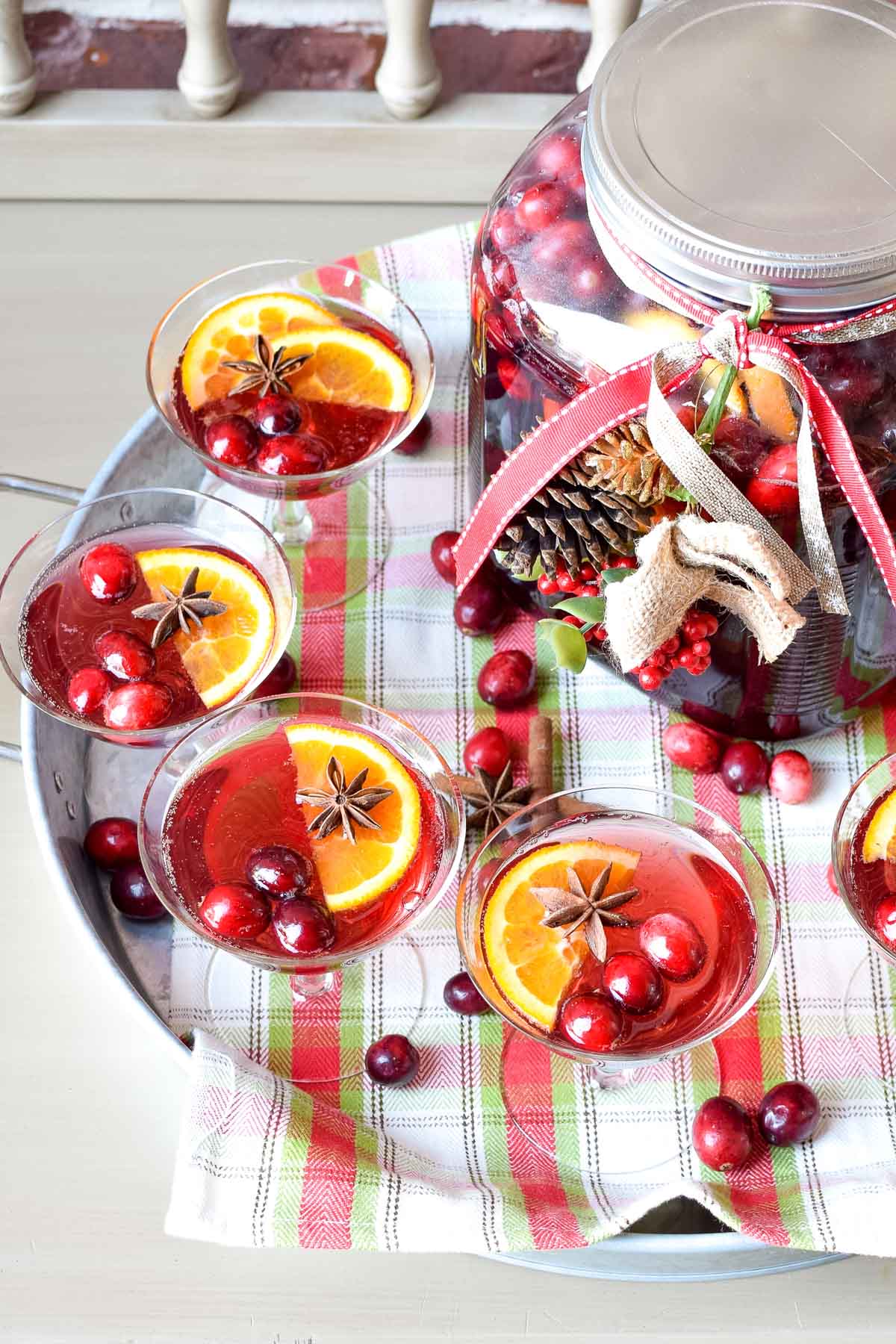 Greet your holiday party guests with a large container of ginger ale and cranberry punch