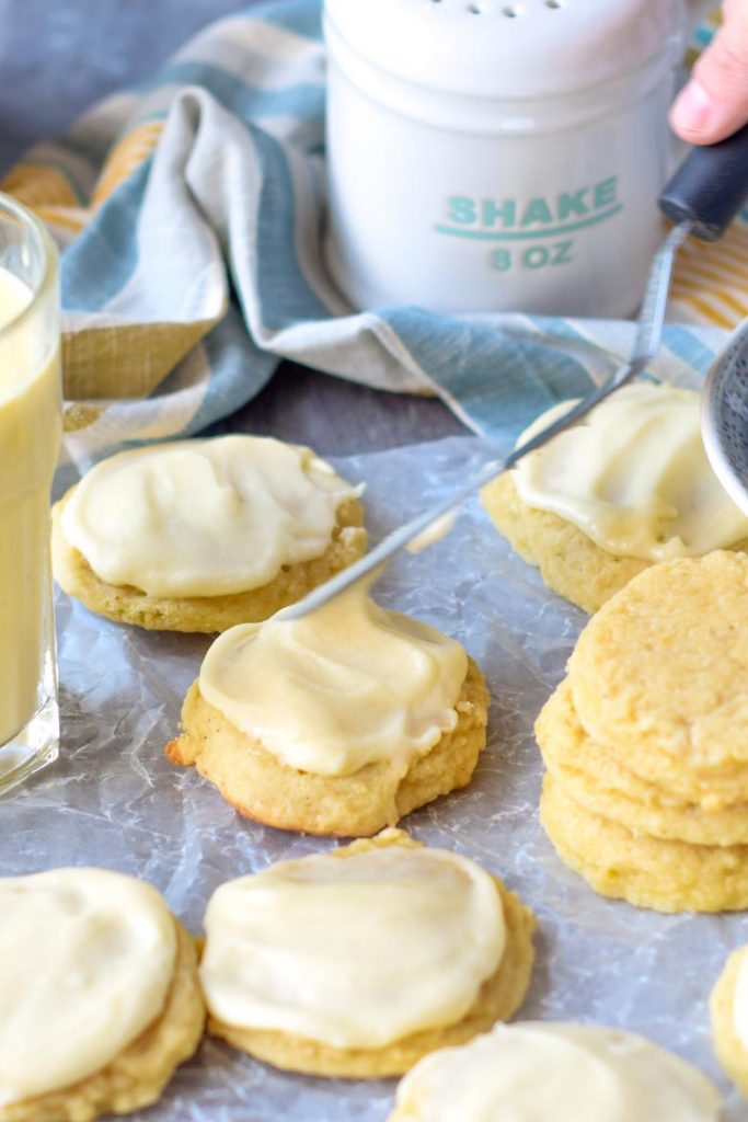 Use an small off set spatula to frost eggnog cookies with eggnog icing