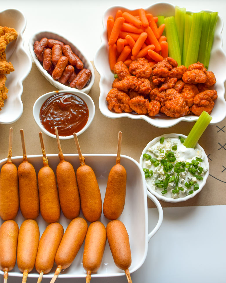 Game day favorites include veggies, buffalo chicken, blue cheese, and lil' smokies