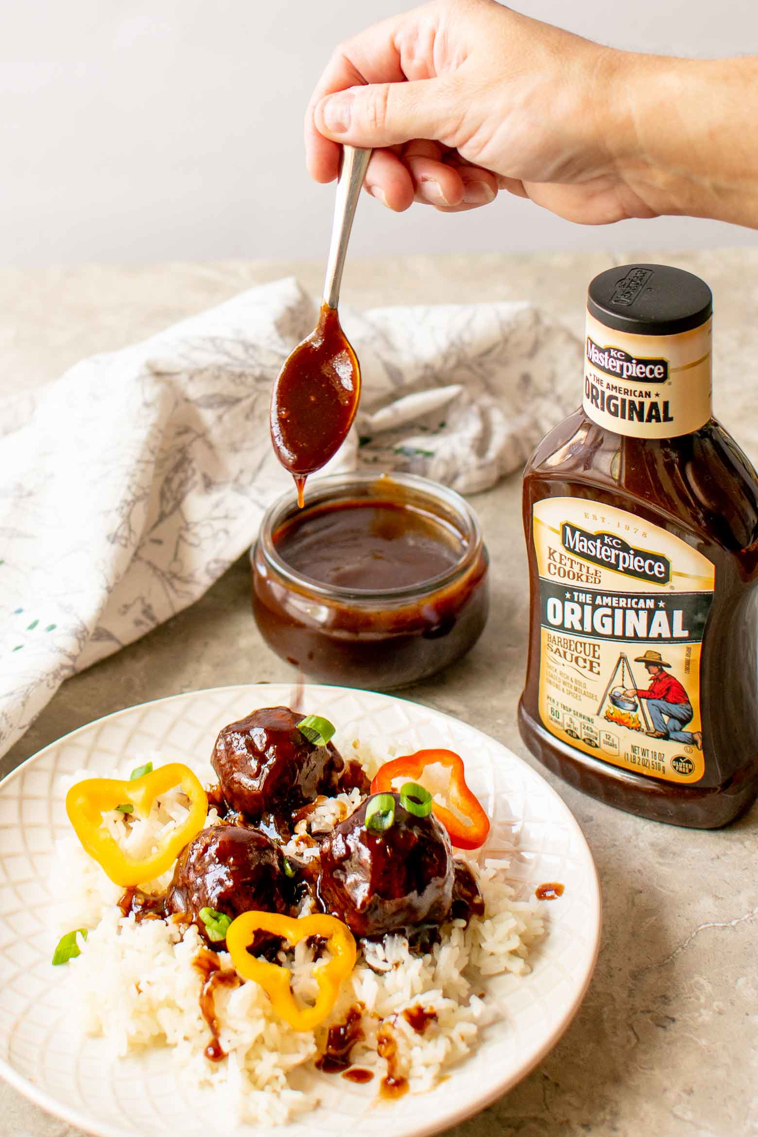 dripping spicy bbq sauce over meatballs
