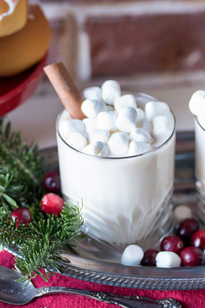 Boozy White chocolate hot chocolate on a tray with a cinnamon stick