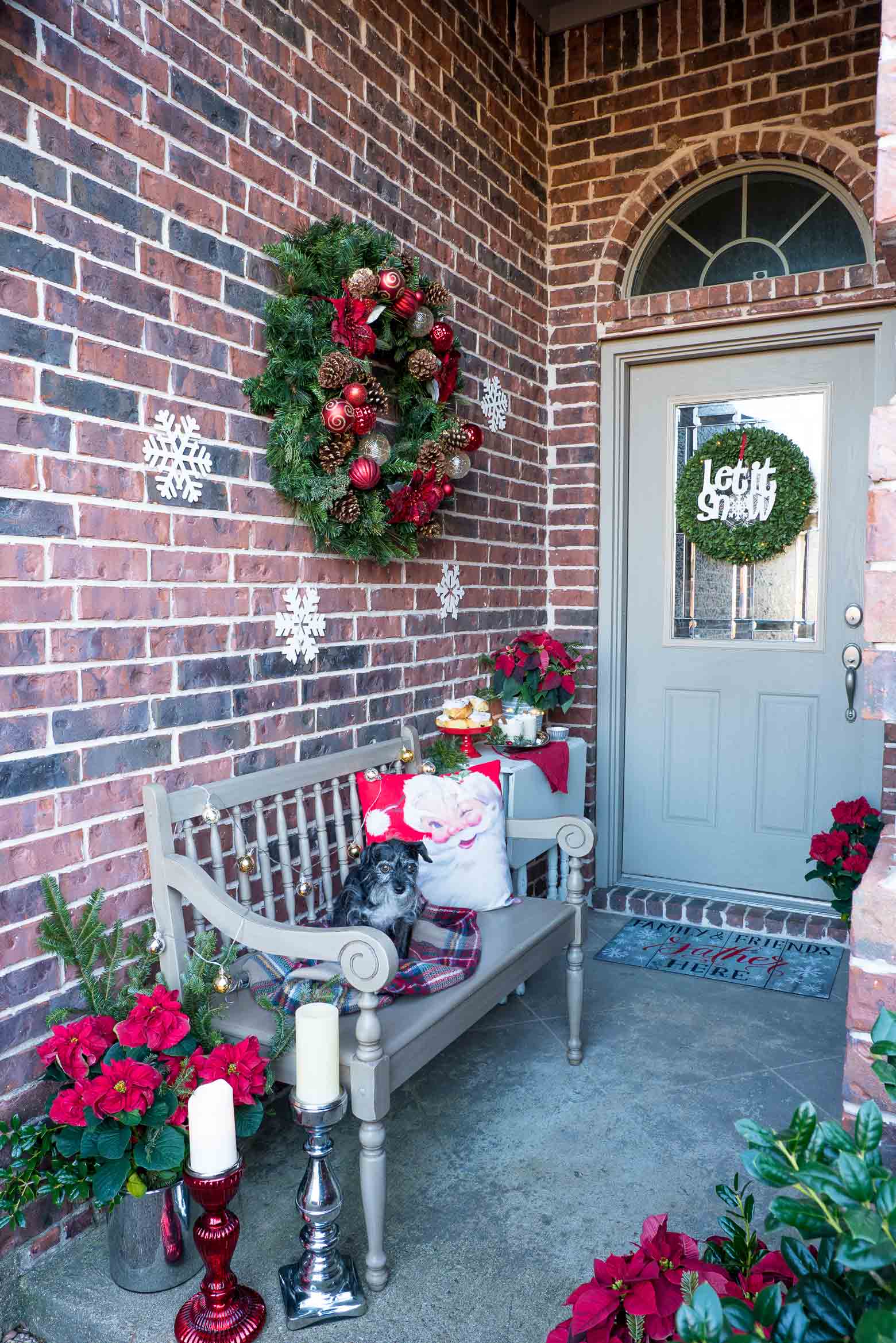 Christmas front porch tour— see all the tips and tricks to use these classic holiday ideas in your own decor. Simple ideas like easy to find evergreen wreaths, poinsettias, candlesticks and both boxwood and evergreen wreaths. Be sure to greet your guests to a drink, like this boozy hot white chocolate! via @mrsmajorhoff