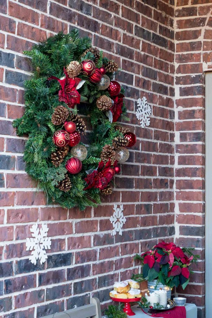 Large holiday wreath on brick wall