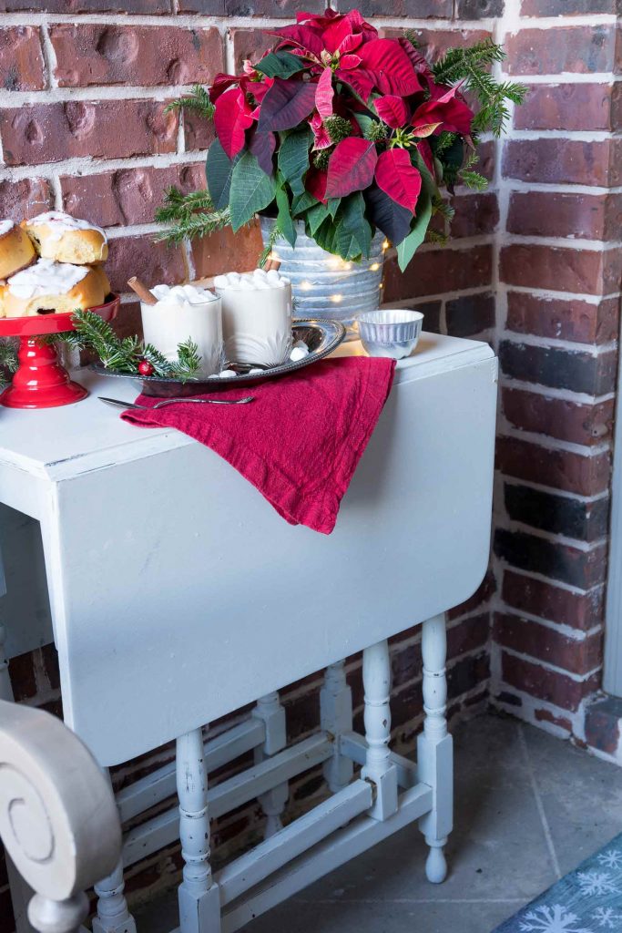 white gate leg table with drinks and dessert on top for Christmas